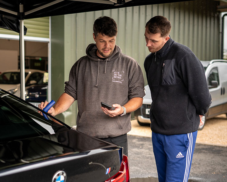 Tom measuring a customers paint